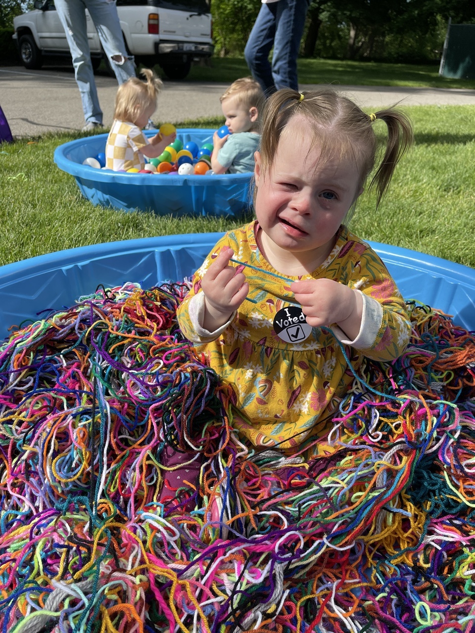 girl playing in a pool of string