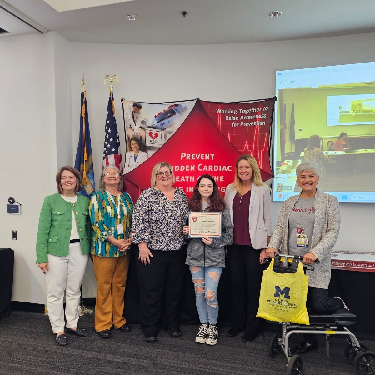 teachers and students with HEARTsafe rep as the accept award