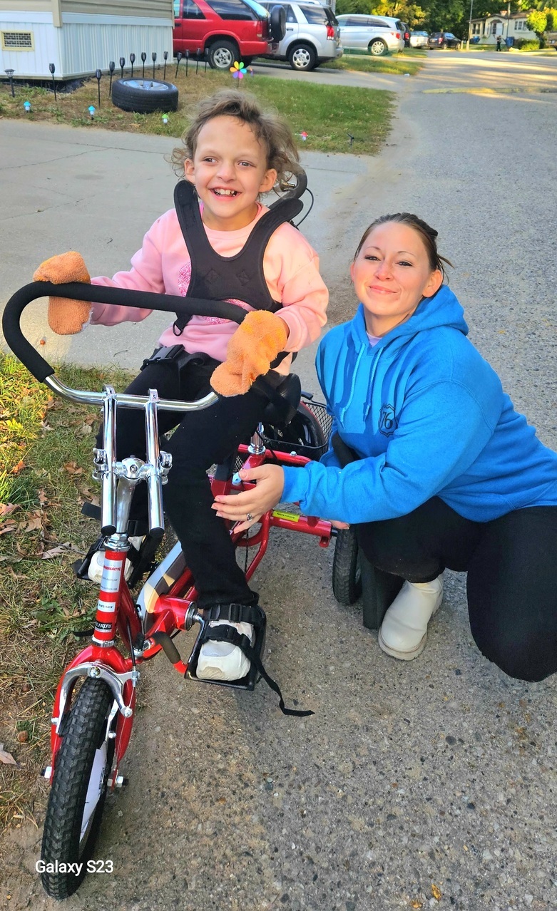 mom with daughter trying out new bike